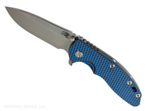 Rick Hinderer Knives XM-18 3.5" Spear Point folding knife with thumb stud and flipper tab - shown open presentation side.  Stonewash MagnaCut stainless steel plain edge blade.   Blue - black G-10 handle with Working Finish lock side.  Model KXM35SPE.