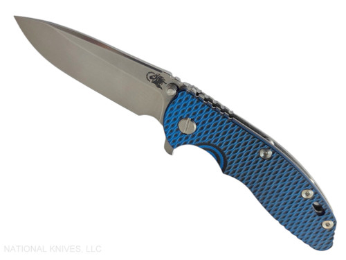 Rick Hinderer Knives XM-18 3.5" Spear Point folding knife with thumb stud and flipper tab - shown open presentation side.  Stonewash MagnaCut stainless steel plain edge blade.  Blue - black G-10 handle with stonewash lock side.  Model KXM35SPE.