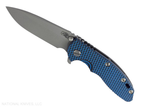 Rick Hinderer Knives XM-18 3.5" Spear Point folding knife with thumb stud and flipper tab - shown open presentation side.  Working Finish MagnaCut stainless steel plain edge blade.  Blue - black G-10 handle with Battle Black lock side.  Model KXM35SPEDLC.