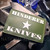 Rick Hinderer Knives Star PVC Morale Patch - obverse.  Green and white with hook and loop backing.  Model A00100PVST.
For reference only.