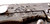 Rick Hinderer Knives Horse Head Logo Fatty XM-18 3.5" Harpoon Tanto folding knife with thumb stud and flipper tab - close up of horse head logo.  Stonewash S35VN stainless steel plain edge blade.  Black G-10 handle with stonewash lock side.  Model K2506SGS00.
For reference only.