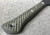 RMJ Tactical Mini Jenny tomahawk - close up of handle obverse shown.  Tungsten Cerakote 80CRV2 steel plain edge head.  Dirty Olive G-10 handle.  
For reference only.