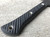RMJ Tactical Mini Jenny tomahawk - close up of handle obverse shown.  Tungsten Cerakote 80CRV2 steel plain edge head.  Black G-10 handle.  
For reference only.