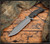RMJ Tactical Combat Africa fixed blade knife - shown out of sheath.  Tungsten Cerakote 80CrV2 steel plain edge blade.  Black G-10 handle scales.  Model K-CA-TU-BK.
