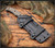 RMJ Tactical Combat Africa fixed blade knife - shown in sheath.  Tungsten Cerakote 80CrV2 steel plain edge blade.  Hyena Brown G-10 handle scales.  Model K-CA-TU-HB.
