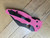 Blemished Spyderco Yojimbo 2 Sprint Run folding knife with thumb hole - shown closed pocket clip side.  Black CPM-S30V stainless steel plain edge blade.  Pink G-10 handle.  Model C85GPNBKP2.