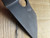 Blemished Spyderco Yojimbo 2 Sprint Run folding knife with thumb hole - close up of pocket clip side blade shown.  Black CPM-S30V stainless steel plain edge blade.  Pink G-10 handle.  Model C85GPNBKP2.