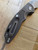 USED Rick Hinderer Knives XM-18 Automatic Bowie knife with push button - shown open pocket clip side handle.  Working Finish S45VN stainless steel plain edge blade.  Battle Bronze titanium handle. 