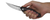 Zero Tolerance 0462 folding knife with flipper tab - shown open in hand.  20CV stainless steel plain edge blade.  Black carbon fiber handle with red highlights.  Model 0462.
