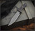RMJ Tactical Jungle Combat fixed blade knife - shown out of sheath reverse.  Tungsten Cerakote Nitro-V stainless steel plain edge blade.  Black G-10 handle.  Model K-JC-NV-TU-BK.