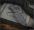RMJ Tactical Jungle Combat fixed blade knife - shown in sheath obverse.  Tungsten Cerakote Nitro-V stainless steel plain edge blade.  Black G-10 handle.  Model K-JC-NV-TU-BK.