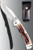 Cold Steel Mackinac Hunter folding knife  with thumb stud - shown open presentation side next to sheath.  AUS-8A stainless steel plain edge blade.  Delrin Faux Stag Horn handle.  Model 54FBTSL.
For reference only.