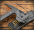 RMJ Tactical Snuggles 18" tactical hammer - shown close up of head obverse.  Tungsten Cerakote 80CRV2 steel head.  Hyena Brown G-10 handle.