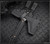 RMJ Tactical Ragnarok 12 tomahawk - close up of tomahawk head in sheath obverse shown.  Tungsten Cerakote 80CRV2 steel plain edge head.  Black G-10 handle.
Model T-R12-TU-BL.