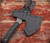 RMJ Tactical Berserker Axe - shown in sheath obverse.  Tungsten Cerakote 80CrV2 steel blade.  Black G-10 handle scales.  