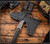 RMJ Tactical Ragnarok 14 tomahawk - shown in sheath reverse.  Tungsten Cerakote 80CRV2 steel plain edge head.  Black G-10 handle.  Model T-R14-TU-BK.