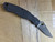 Used Spyderco Military 2 Salt folding knife with thumb hole - shown open presentation side.  Black CPM MagnaCut stainless steel plain edge blade.  Black G-10 handle.  Model C36GMCBKP2.