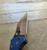 Blemished Yojimbo 2 folding knife with thumb hole - close up of pocket clip side blade shown.  Satin SPY27 stainless steel plain edge blade.  Blue G-10 handle.  Model C85GPCBL2.
