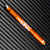 Rick Hinderer Knives Investigator ink pen - shown with cap on.  Flames matte orange aluminum construction.  Model P5801FA4ORA.
