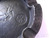 RMJ Tactical Gold Point Forge Ashtray - shown close up of obverse.  Solid steel construction featuring a Catacombs pattern.
