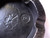 RMJ Tactical Gold Point Forge Ashtray - shown close up of obverse.  Solid steel construction featuring a Catacombs pattern.