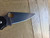 Blemished Spyderco Paramilitary 2 folding knife with thumb hole - close up of pocket clip side blade shown.  Satin CTS-BD1N stainless steel plain edge blade.  Black FRN handle.  Model C81PBK2.