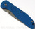 Rick Hinderer Knives Firetac Recurve folding knife with thumb disk - shown closed presentation side.  Working Finish 20CV stainless steel plain edge blade.  Blue G-10 handle with Battle Blue lock side.  Model K205FSGW00.