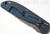 Rick Hinderer Knives Firetac Recurve folding knife with thumb disk - shown closed lock side.  Working Finish 20CV stainless steel plain edge blade.  Blue G-10 handle with Battle Blue lock side.  Model K205FSGW00.