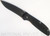 Rick Hinderer Knives Firetac Recurve folding knife with thumb disk - shown open presentation side.  Battle Black 20CV stainless steel plain edge blade.  Black G-10 handle with Battle Black lock side.  Model K205FSGD00.