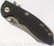 Rick Hinderer Knives XM-18 3.0" Skinner folding knife with thumb studs and flipper tab - shown closed presentation side.  Working Finish 20CV stainless steel plain edge blade.  Black G-10 handle with Working Finish lock side.  Model K1041SGW00.