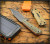 RMJ Tactical UCAP fixed blade knife - shown out of sheath obverse.  Tungsten Cerakote Nitro-V stainless steel plain edge blade.  Blaze Olive G-10 handle.