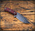 RMJ Tactical UCAP fixed blade knife - shown out of sheath obverse.  Textured black Cerakote Nitro-V stainless steel plain edge blade.  Black Widow G-10 handle.