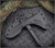 RMJ Tactical Kestrel tomahawk - close up of head in sheath obverse.  Black Cerakote 80CRV2 steel plain edge head.  Black G-10 handle.