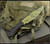 RMJ Tactical National Knives, LLC Exclusive 3V Syndicate Jungle Combat fixed blade knife - shown out of sheath obverse.  Jungle Camo colored 3V steel plain edge blade.  Black G-10 handle.  Model K-JC-3V-JC.
For reference only.
