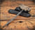 RMJ Tactical 3V Syndicate Akuto push spike - shown laying on top of Kydex sheath.  Colbalt Cerakote 3V steel spike.  Hyena Brown G-10 Handle.  Model AK-3V-HB.