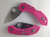 Spyderco Dragonfly 2 JB Outman Exclusive folding knife with thumb hole - shown open presentation side and closed pocket clip side.  Satin VG-10 stainless steel plain edge blade.  Pink FRN handle.  Model C28PPN2.
For reference only.