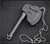 RMJ Tactical Mortifer Mini Tomahawk pendant - shown in sheath obverse.  Dark Antracite Cerakote Nitro-V stainless steel construction. 