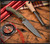 RMJ Tactical Sparrow fixed blade knife - shown out of sheath reverse.  Tungsten Cerakote MagnaCut stainless steel plain edge blade.  Dirty Olive G-10 handle.  Model K-SP-MC-TU-DO.
