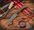 RMJ Tactical Sparrow fixed blade knife - shown out of sheath obverse.  Tungsten Cerakote MagnaCut stainless steel plain edge blade.  Dirty Olive G-10 handle.  Model K-SP-MC-TU-DO.
