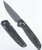Tactile Knife Co Maverick folding knife with thumb stud - shown open pocket clip side and closed presentation side.  Stonewash MagnaCut stainless steel plain edge blade.  Black camo carbon fiber handle.