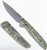 Tactile Knife Co Maverick folding knife with thumb stud - shown open pocket clip side and closed presentation side.  Stonewash MagnaCut stainless steel plain edge blade.  Toxic Storm carbon fiber handle.