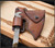 RMJ Tactical Custom Raven bearded Axe - shown close up of head in sheath reverse.  80CRV2 steel plain edge head.  Laser engraved Linen Micarta.  Model T-RS-FS-SH-LM.