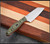 RMJ Tactical Osprey 9 Adventure kitchen knife - shown out of sheath obverse.  14C28N stainless steel plain edge blade.  Blaze Olive G-10 handle.  Model K-OSP9-SW-BO
