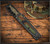 RMJ Tactical Lady Death fixed blade knife - shown in sheath obverse.  Graphite Black Cerakote 3V steel plain edge blade.  Dirty Olive G-10 handle.  Model K-LD-3V-GB-DO-BW.