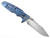 Rick Hinderer Knives Skinny Eklipse Slicer folding knife with flipper tab - shown open - lock side.  Stonewashed 3.5" hollow grind MagnaCut stainless steel plain edge blade.  Orange G-10 handle scale with stonewash blue lock side.  Model KEK35SKSLHO