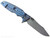 Rick Hinderer Knives Skinny Eklipse Slicer folding knife with flipper tab - shown open - lock side.  Working Finish 3.5" hollow grind MagnaCut stainless steel plain edge blade.  OD green G-10 handle scale with Battle Blue lock side.  Model KEK35SKSLHO