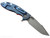 Rick Hinderer Knives XM-18 Skinny Harpoon Spanto with thumb stud and flipper tab - shown open lock side.  Working Finish MagnaCut stainless steel plain edge blade.  Orange G-10 handle with Battle Blue lock side.  Model KXM35SKHS.
