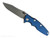 Rick Hinderer Knives Skinny Eklipse Slicer folding knife with flipper tab - shown open - presentation side.  Working Finish 3.5" hollow grind MagnaCut stainless steel plain edge blade.  Blue - black G-10 handle scale with Battle Bronze lock side.  Model KEK35SKSLHO