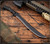 RMJ Tactical Drake fixed blade knife - shown out of sheath obverse.  Textured Black MagnaCut steel plain edge blade.  Black G-10 handle scales.  Model K-DR-MC-BT-BK.