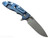 Rick Hinderer Knives XM-18 3.5" Slicer Hollow Grind folding knife with thumb stud and flipper tab - shown open lock side.  Working Finish 20CV stainless steel plain edge blade.  OD green G-10 handle with Battle Blue lock side.  Model KXM35SLHO.